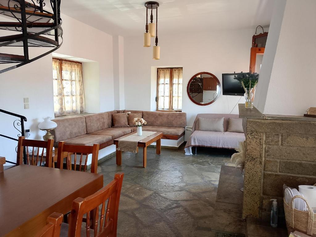 a living room with a couch and a table at VintageVilla in Skala Marion