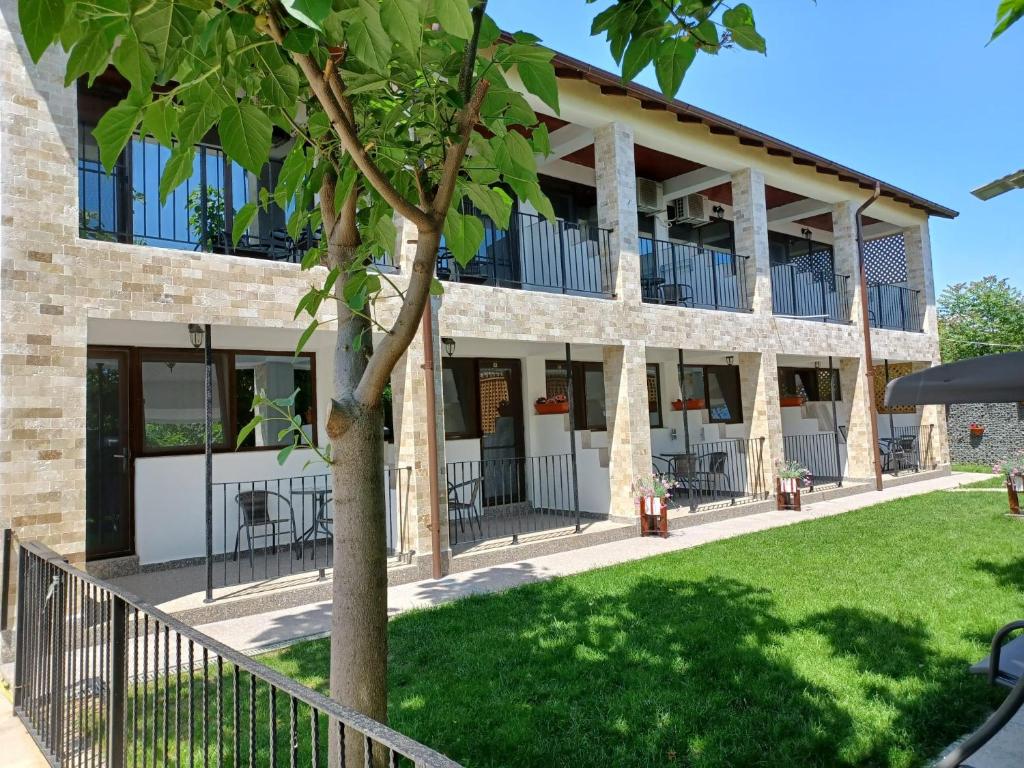 a building with a tree in front of it at Vila Lara 2 Mai in 2 Mai