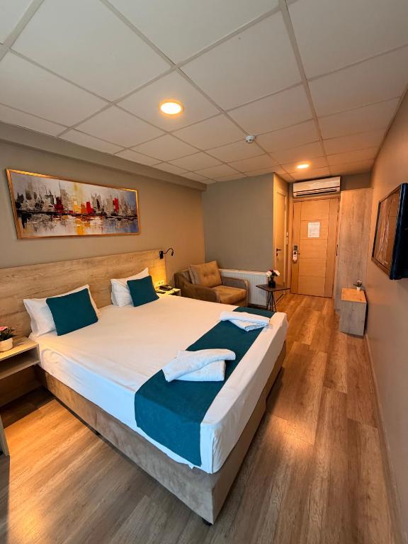 a bedroom with a large bed and a couch at Rota Kadıköy in Istanbul