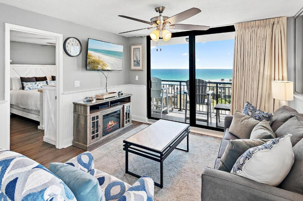 a living room with a couch and a fireplace at SunDestin 818 in Destin