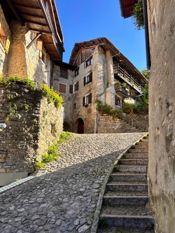 a stone alley with stairs leading to a building at Le Orme in Tenno