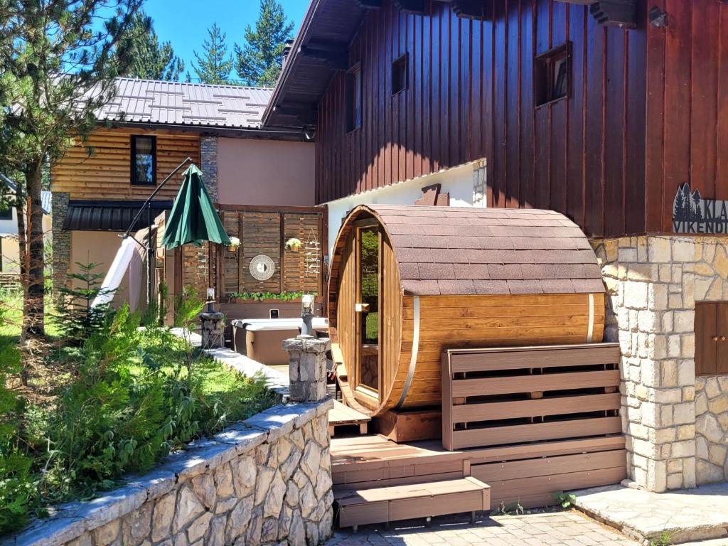 a large wooden building with a hobbit house at Blidinje Klara in Blidinje