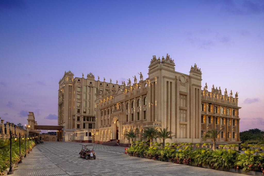 a large building with lights in front of it at Blueworld Castles in Kānpur