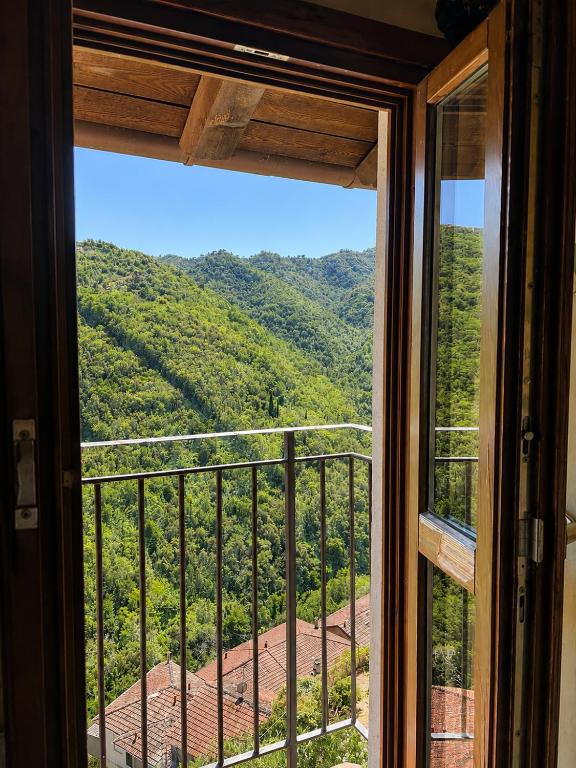 a window with a view of a mountain view at La Rocca Sospesa in Apricale