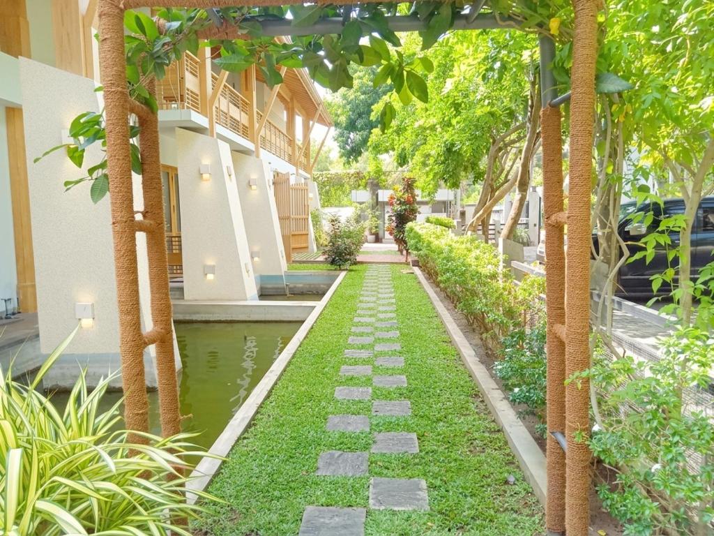 a garden with a walkway in front of a building at Serenity Tissa in Tissamaharama