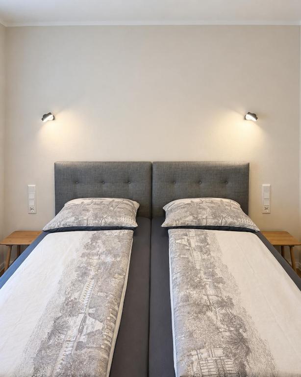 two beds sitting next to each other in a room at Steinweg 7 Ferienwohnung in Kassel