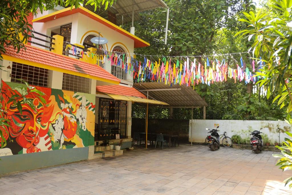 a building with colorful flags hanging from it at Kulture KonnectT Kurakanni in Varkala