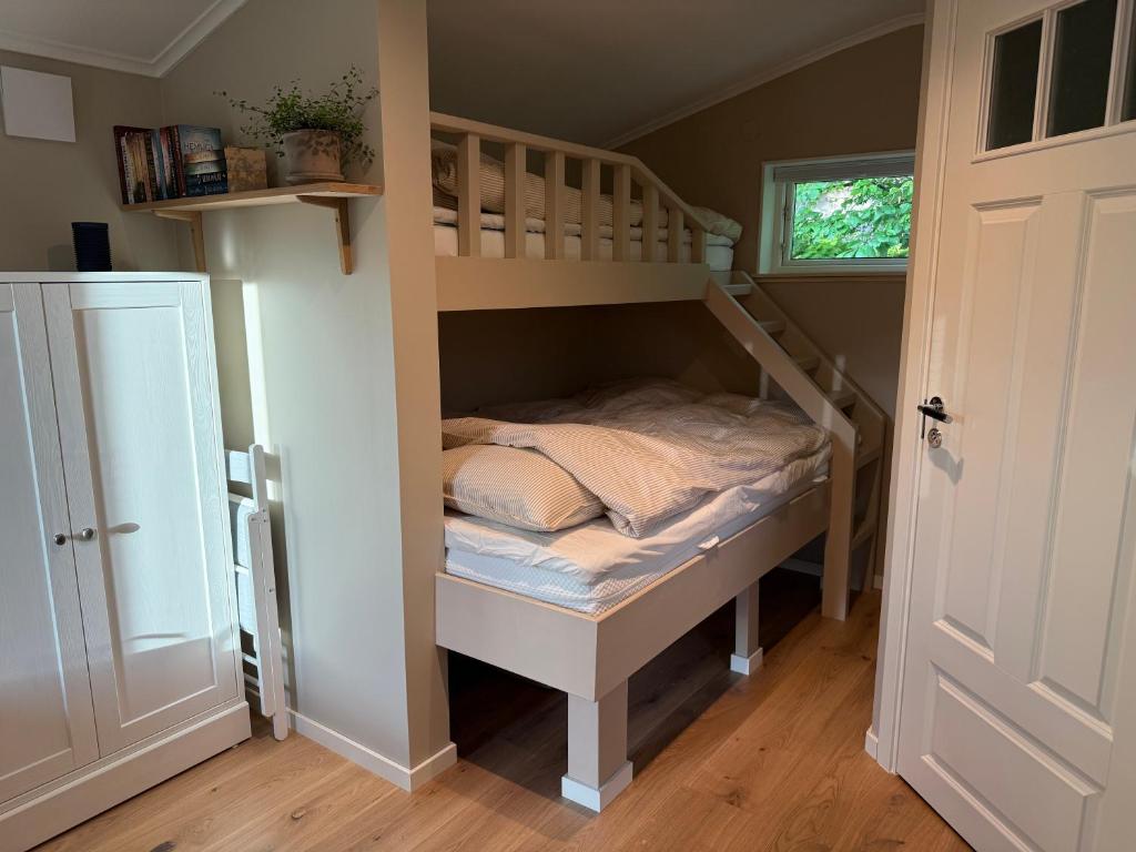 a bedroom with a bunk bed with a ladder at Stuga Marstrand in Marstrand