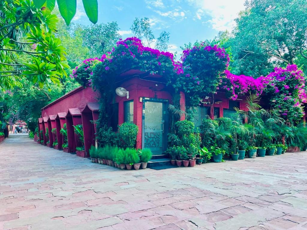a building covered in flowers and plants on a street at Hotel Sheela, 100m from Taj Mahal in Agra