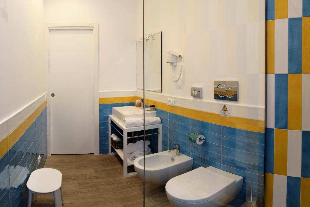 a bathroom with a toilet and a sink at Dea Guest House in Sorrento