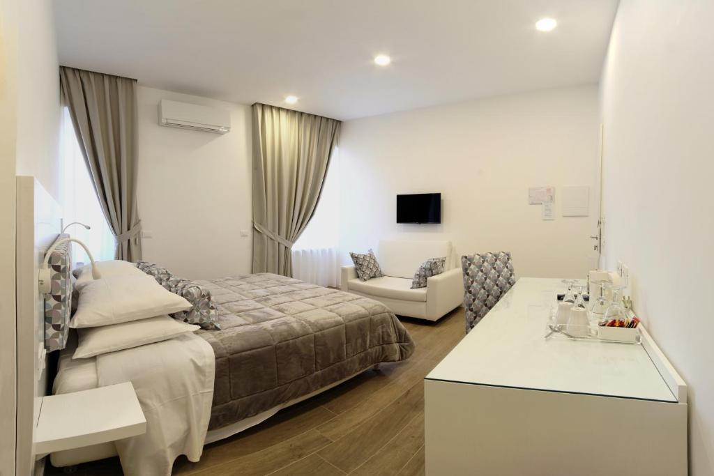 a bedroom with a bed and a living room at Dea Guest House in Sorrento