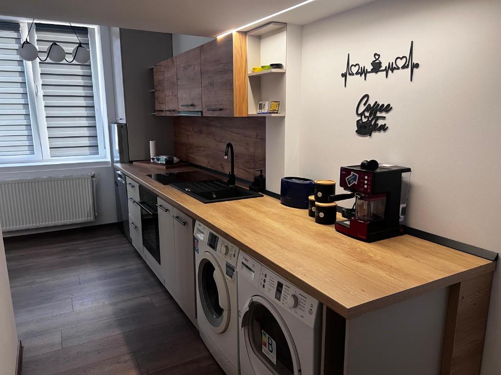 a kitchen with a counter top with washing machines at RUX Central Park in Petroşani
