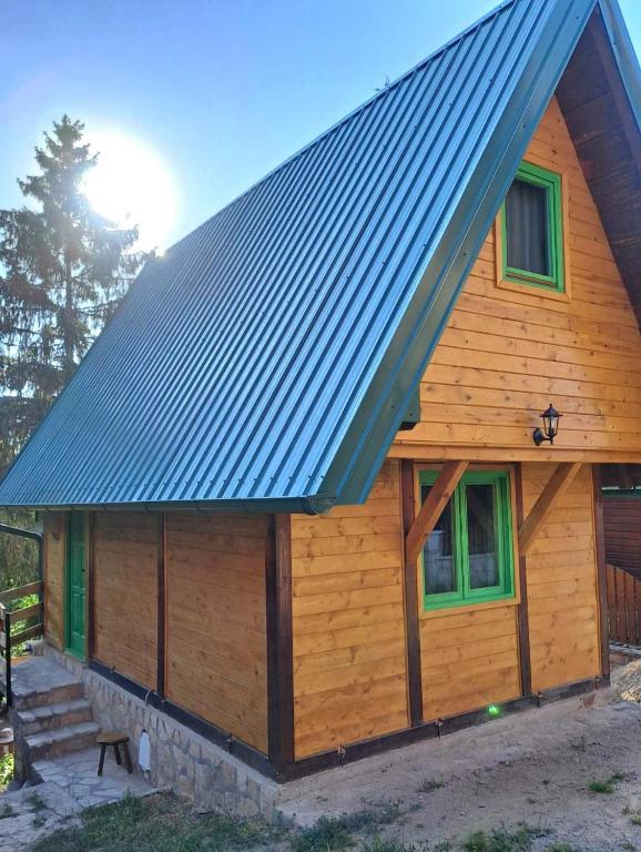 a log cabin with a metal roof at Vikendica Breza 2 in Zaovine