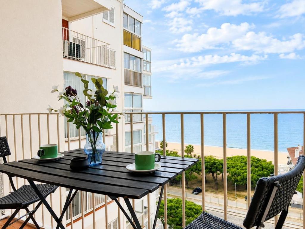 a balcony with a table and chairs and the ocean at Mediterranean Escape - Sea Views Pool in Malgrat de Mar