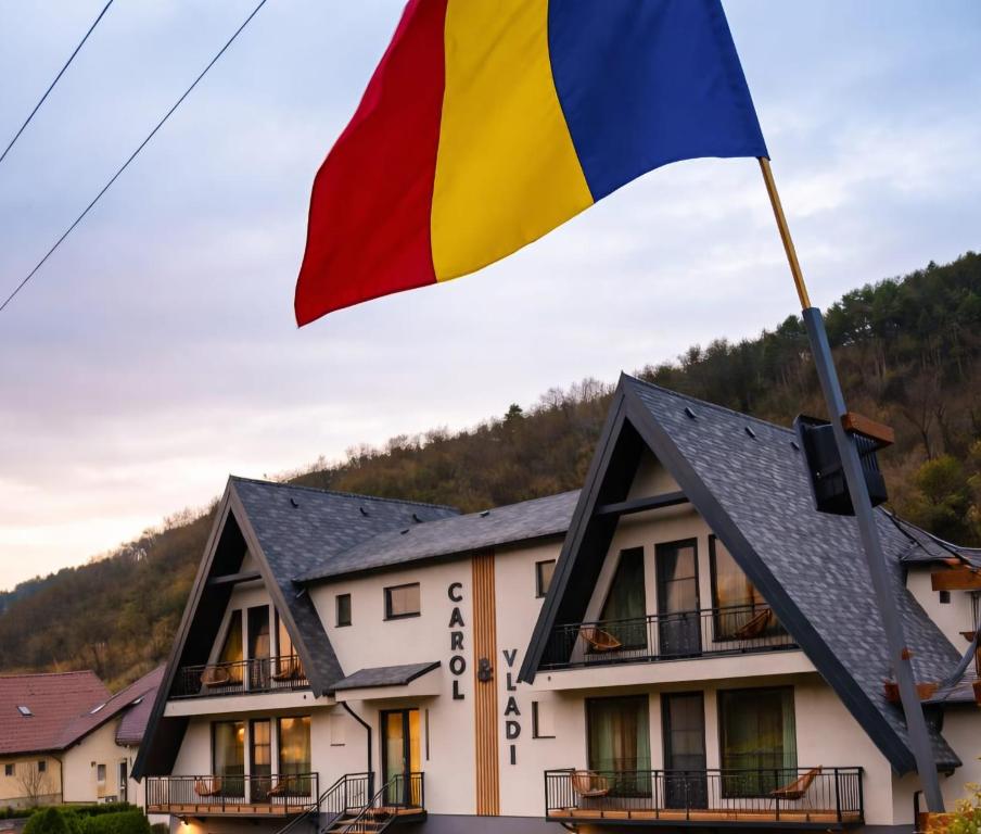 a flag flying over a building at Residence by Carol&Vladi in Târgu Ocna