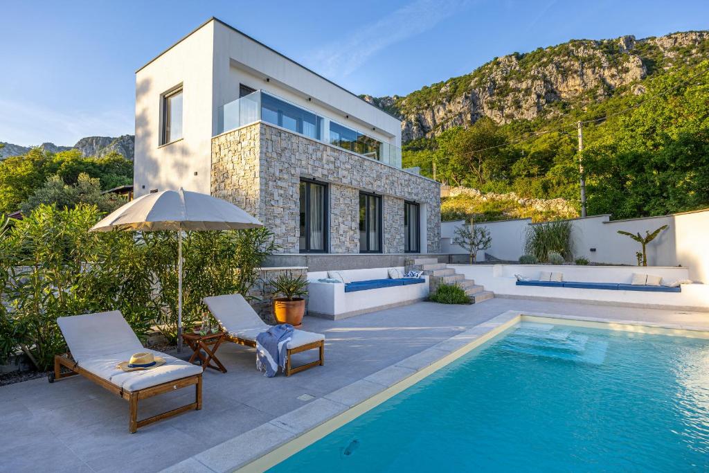 a villa with a swimming pool and a house at Villa Noha in Bribir