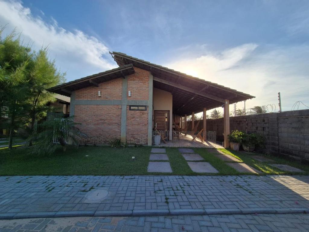 a brick building with aicked yard in front of it at Casa Brisas 17 in Luis Correia