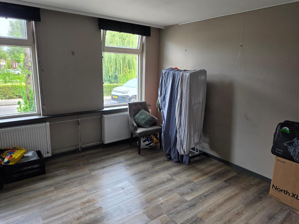 an empty room with a chair and a window at Appartment on Dorpsstraat in Bleskensgraaf