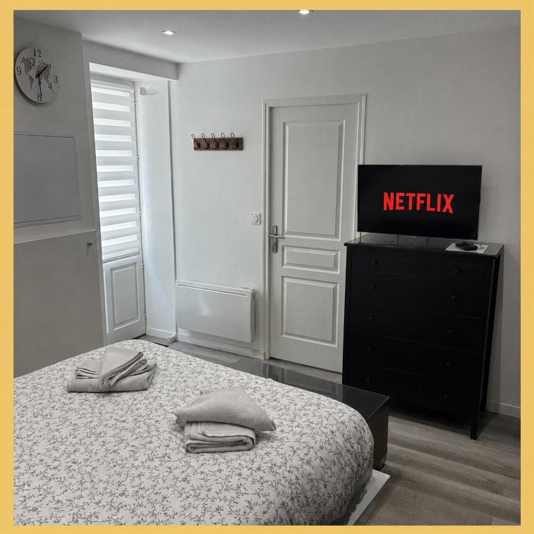 a bedroom with a bed with two towels on it at Studio tout équipé in Vaugneray
