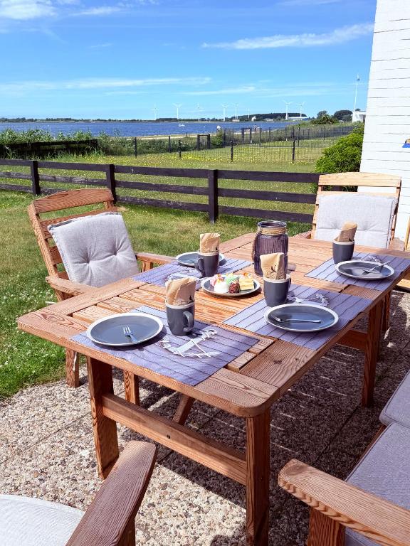 a wooden table with plates of food on it at Utkiek in Fehmarn