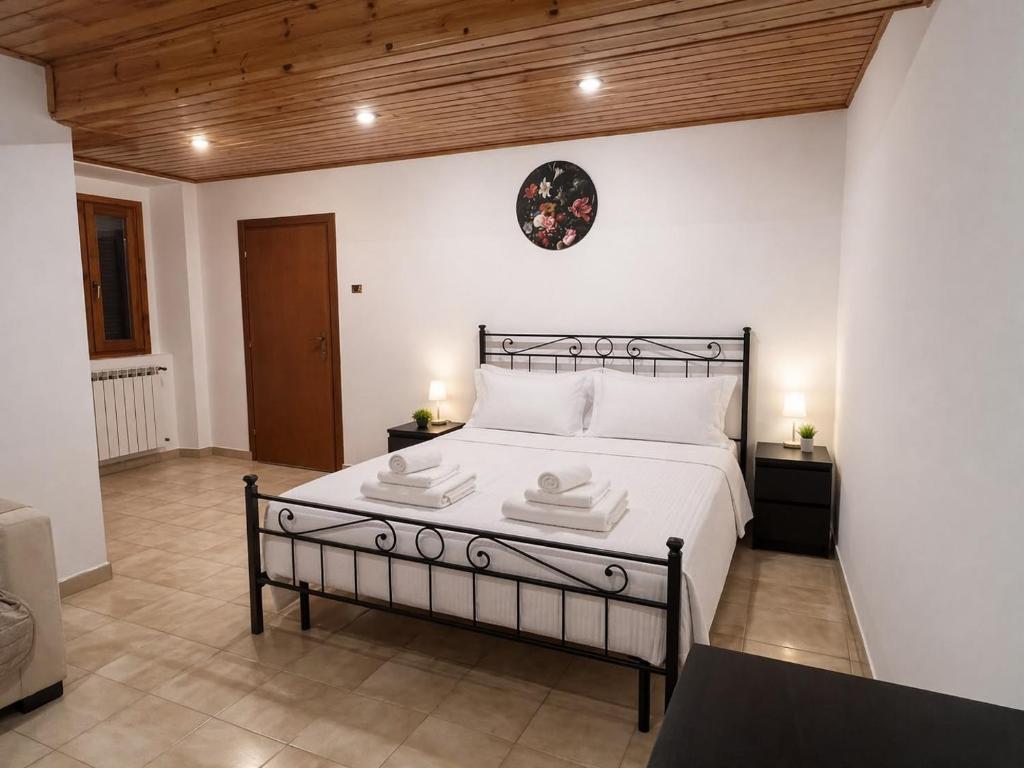 a bedroom with a bed with two towels on it at Varese City Center BnB in Varese