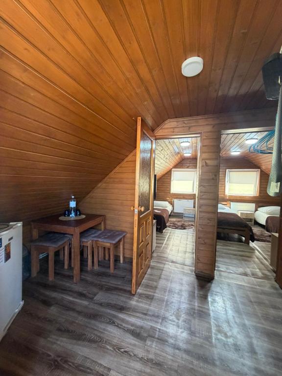 a room with a table and a wooden ceiling at Садиба Сойми in Soymy