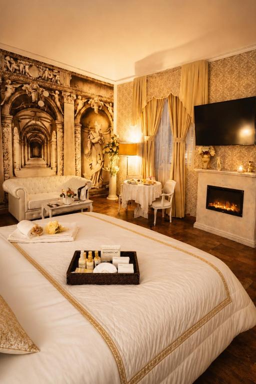 a bedroom with a large bed with a fireplace at Barberini Dream in Rome