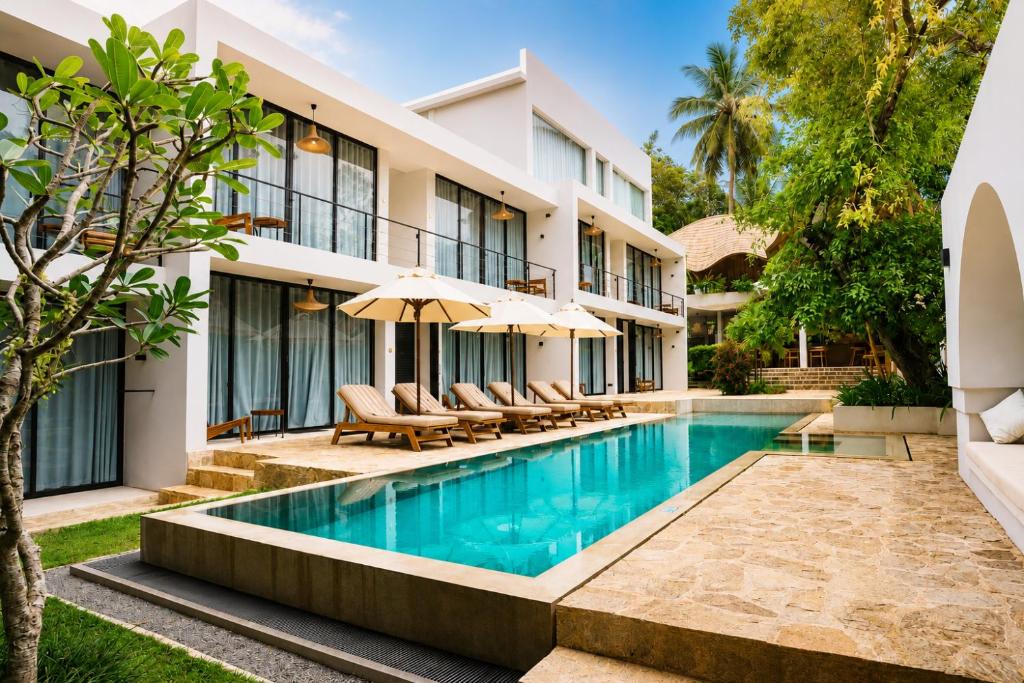 an exterior view of a hotel with a swimming pool at Terra Resort in Ahangama