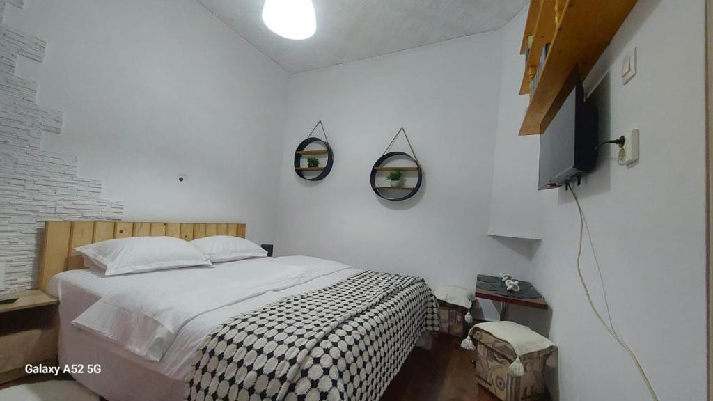 a bedroom with a bed and two mirrors on the wall at Casa Iacob in Sighişoara