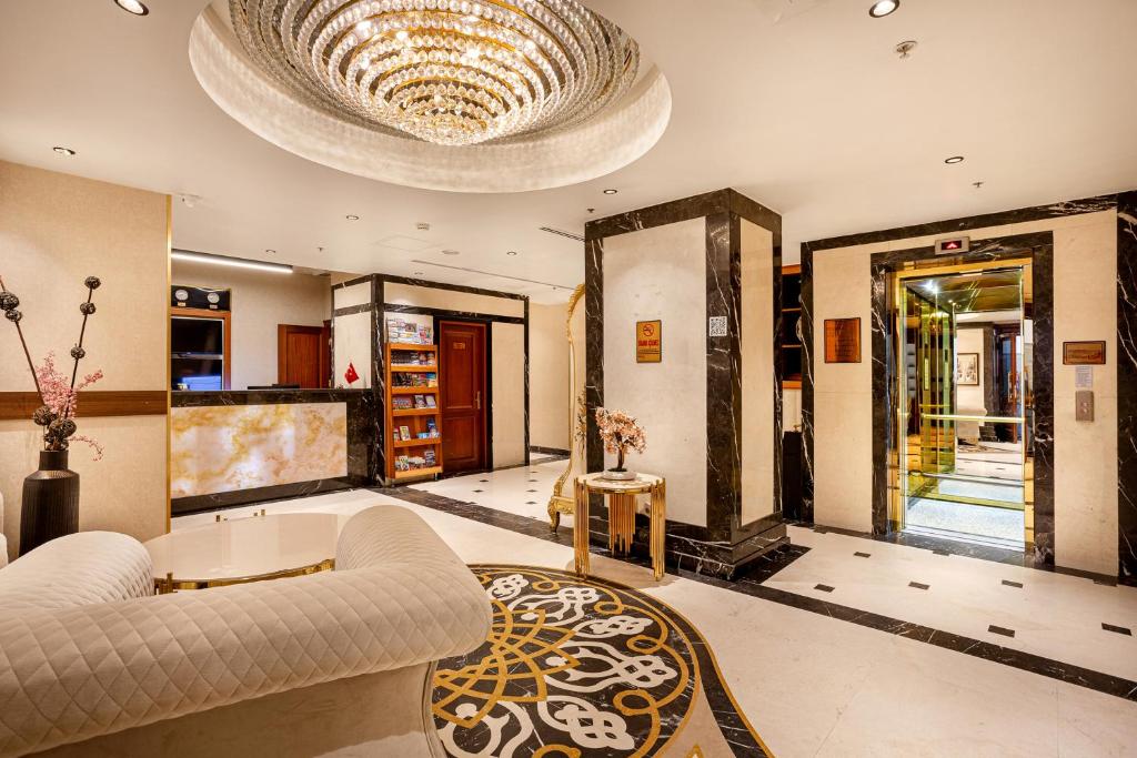 a living room with a couch and a chandelier at The central hotel in Istanbul