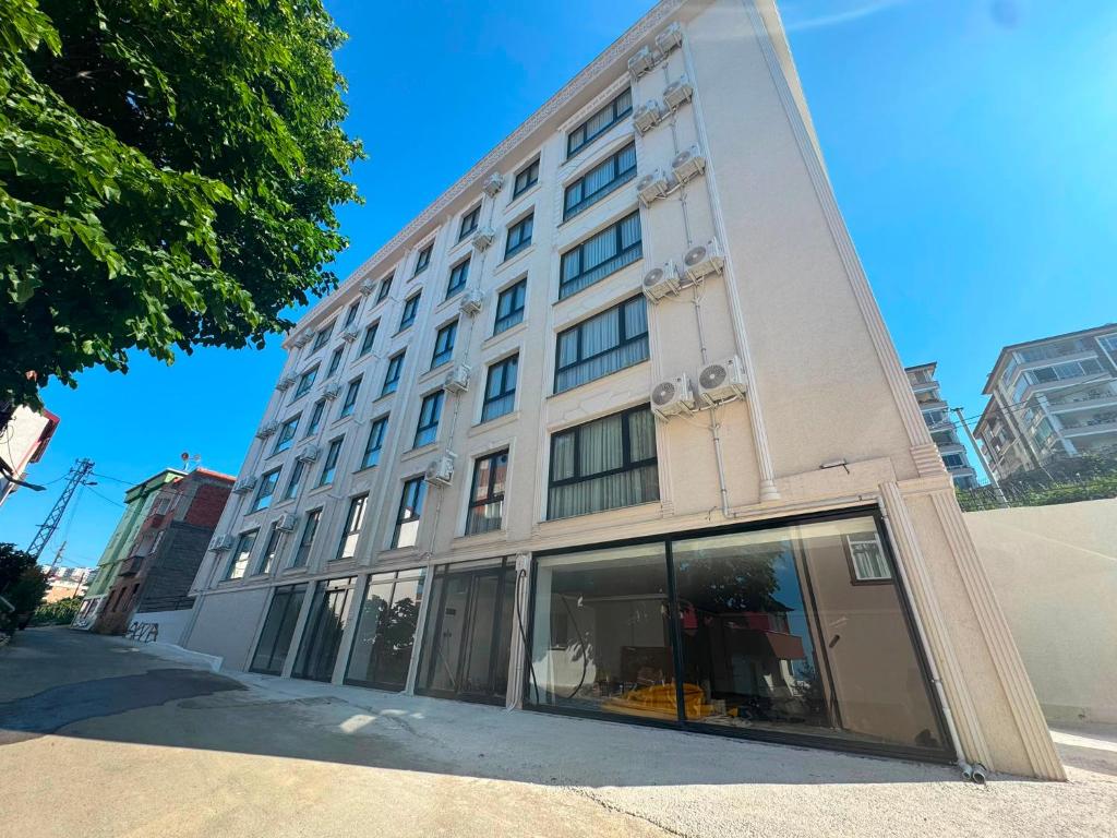 a large white building with windows on a street at Atlas Suite Trabzon in Trabzon