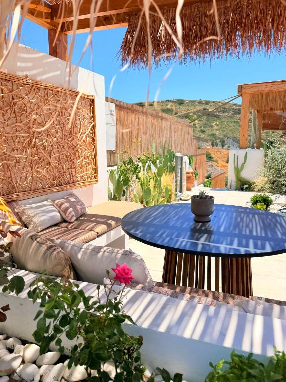 a patio with a table and a couch at Apademia Comfort Studio 65sqm in Skiros