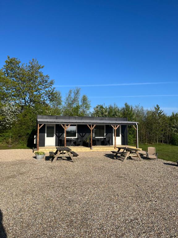 a picnic shelter with picnic tables in front of it at Varde Bed and Kitchen Annekset in Varde