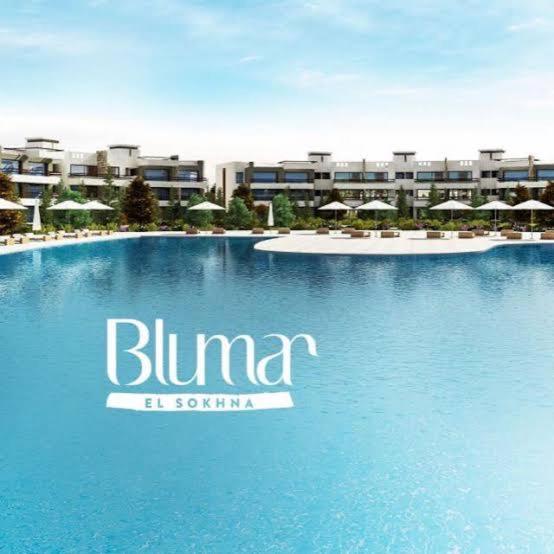 a swimming pool in front of a resort at Blumar El Sokhna in Ain Sokhna