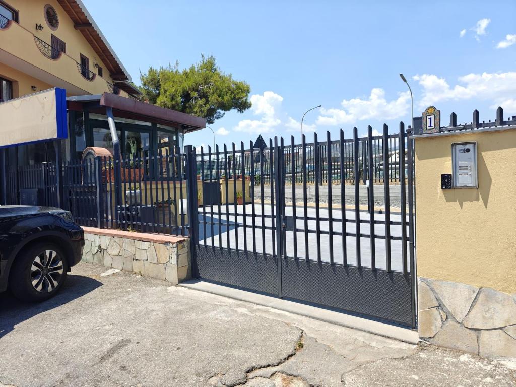 a black gate in front of a building at My Sicily apartments in Taormina