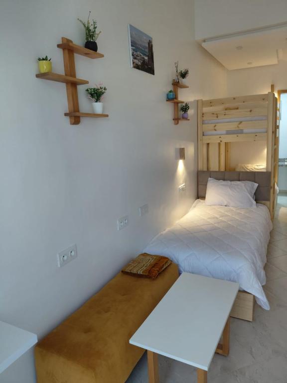 a bedroom with a bed and a cross on the wall at Studio cozy 04 in Tangier