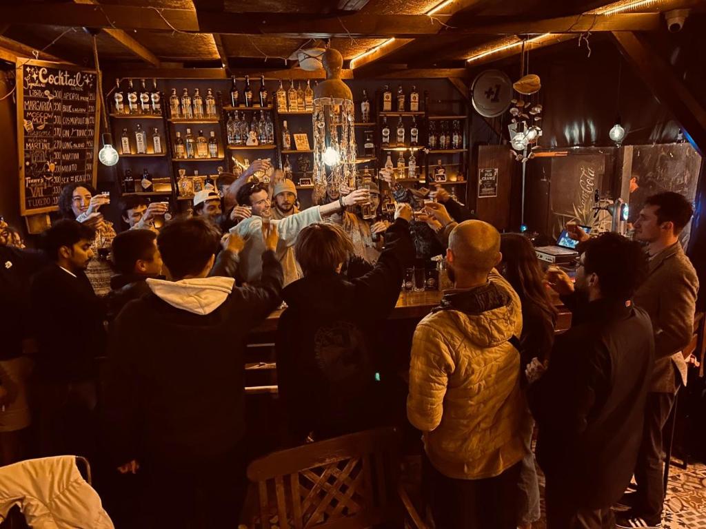 a group of people standing around a bar at Gold Coast Hostel in Antalya