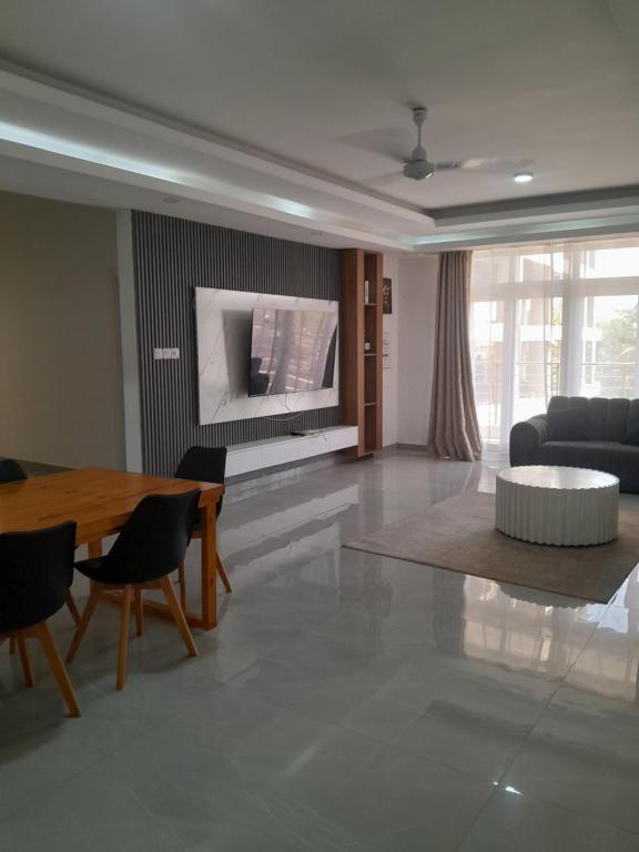 a living room with a table and a couch at Aqua garden in Mombasa