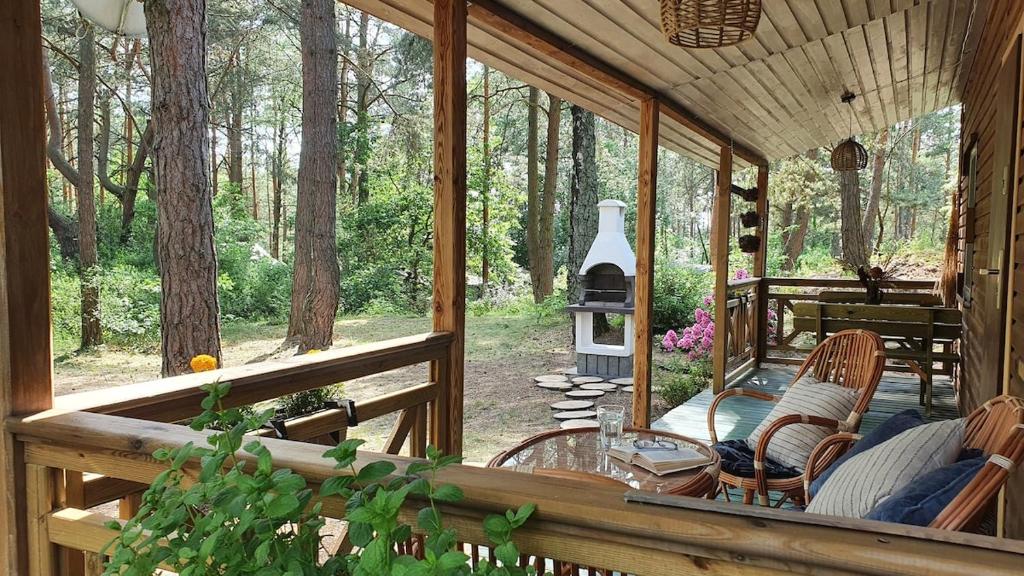 a screened in porch with a table and a stove at Forest Edge Retreat in Wizna