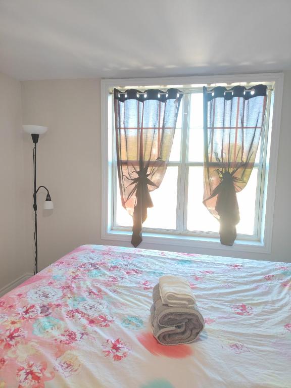 a bed in a room with a window and a blanket at Central Light-Filled 3rd Floor -3C in Halifax