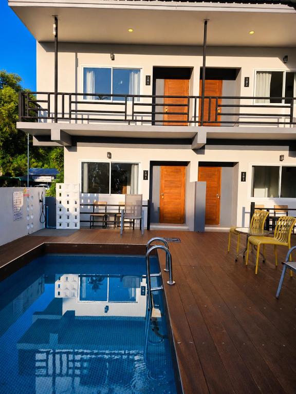 a house with a swimming pool in front of a house at Nangkam Boutique House in Ko Phi