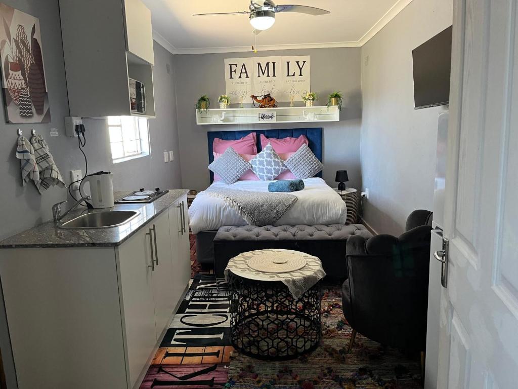 a small kitchen with a bed in a room at Peace House in Pietermaritzburg
