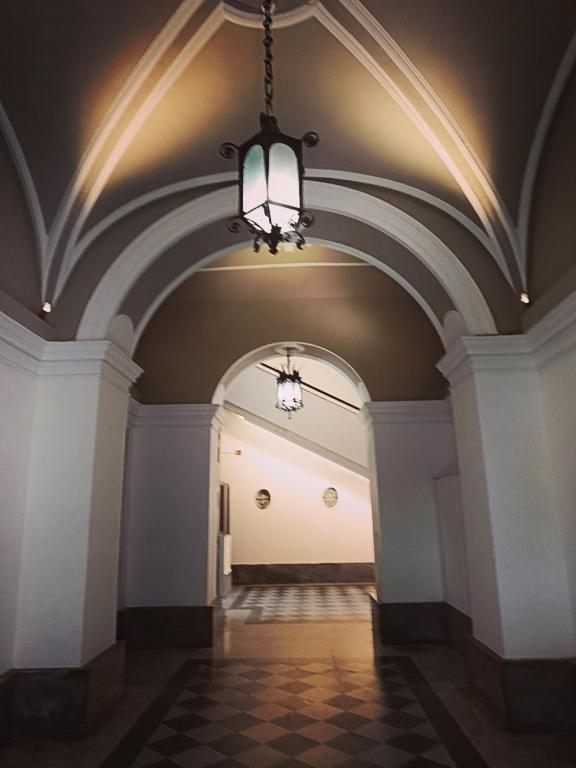 an empty hallway with a chandelier in a building at Studio64 in Civitavecchia