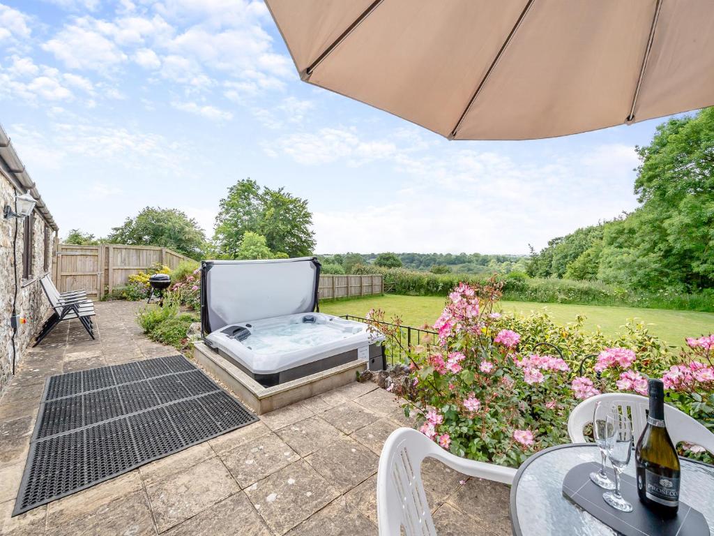 a garden with a hot tub on a patio at Holgates in Upottery