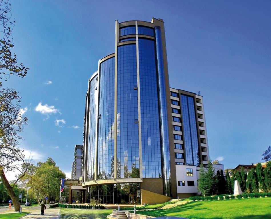 a tall building with a lot of windows at Rosslyn Dimyat Hotel Varna in Varna City
