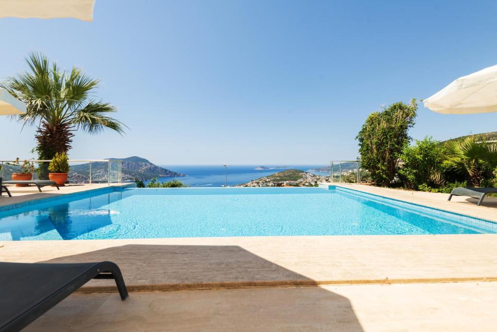 a swimming pool with a view of the ocean at Villa Yakamoz in Kalkan