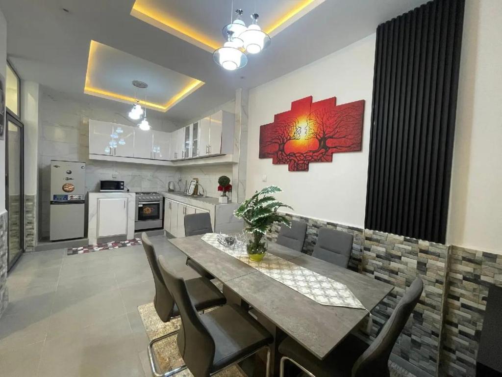 a kitchen and dining room with a table and chairs at Mamelle in Dakar