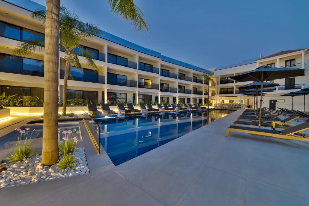 an exterior view of a hotel with a swimming pool at La Finestra in Nydri