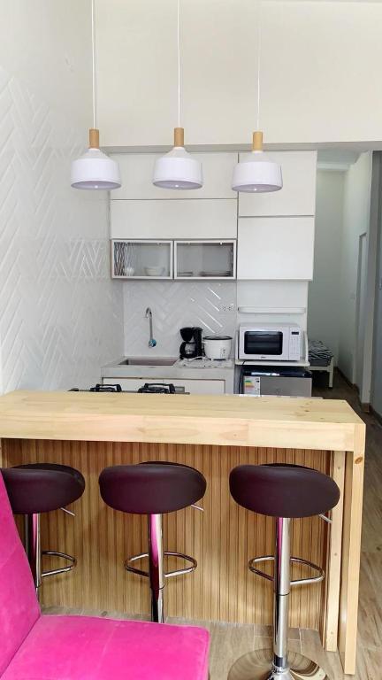 a kitchen with a counter and some stools in a room at Apartmento en Chiclayo in Chiclayo
