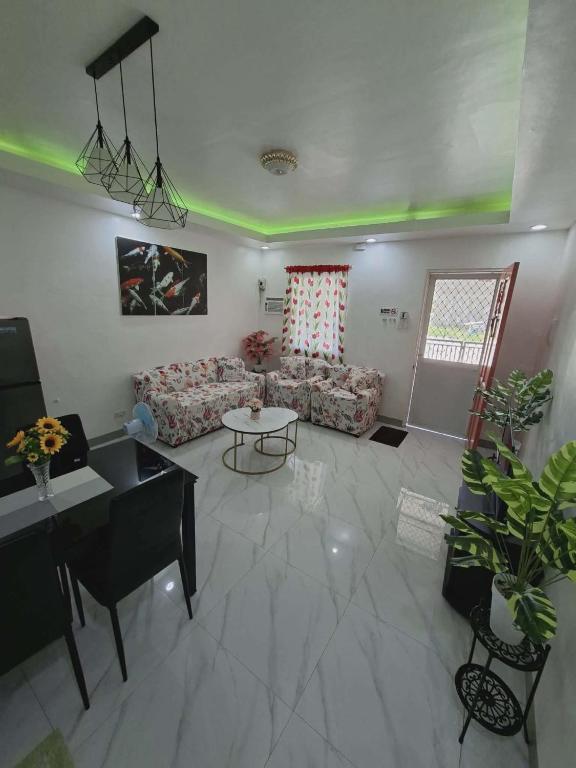 a living room with a couch and a table at Compostela Two Story Richwood Townhome Breakfast Offered in Compostela